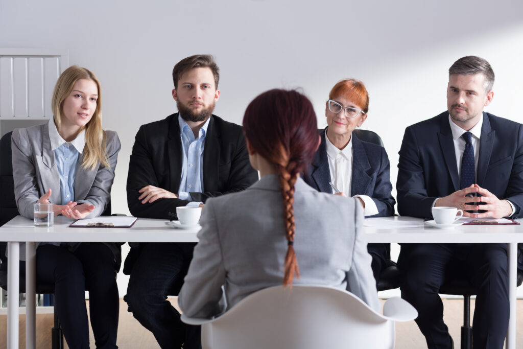 An applicant talking to recruiters in a sales interview.
